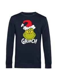 Sudadera de color marino con un gráfico del Grinch en verde que lleva un gorro de Santa rojo y blanco. El texto dice "GRINCH" en letras blancas y en negrita debajo del diseño.