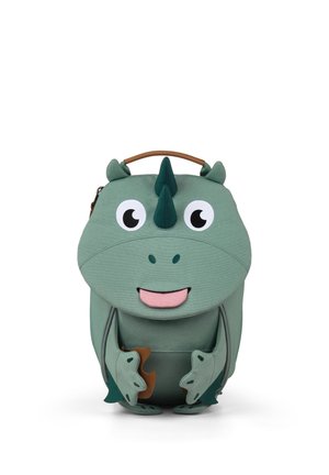 Green dinosaur-shaped children's backpack with big eyes, small horns, smiling mouth, and front pockets resembling dinosaur limbs.
