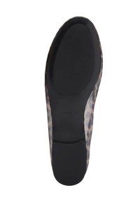 Leopard print flat shoe sole with a textured black rubber bottom and smooth pattern around the edge. Features a rounded toe design.