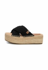 Sandalias de plataforma tejidas negras con suela de cuerda, tiras cruzadas y una plantilla color marrón claro, que presentan un pequeño logo metálico en la tira.
