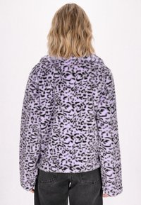 Lila fuskpälsjacka med svart leopardmönster, med en avslappnad passform och långa ärmar. Mjuk textur, rundad krage.