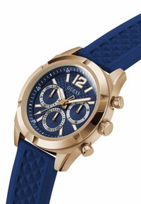 Orologio cronografo in tono oro con quadrante blu texturizzato, bracciale in gomma blu e rifiniture argentate. Caratterizzato da tre sottodial e indici delle ore ben visibili.
