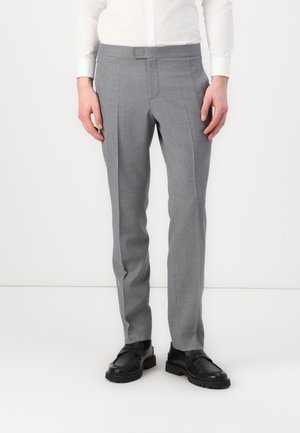 Gray tailored trousers with a smooth texture, featuring front pleats and a slim fit design, paired with black shoes.