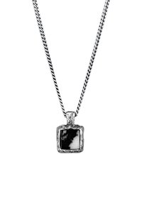 Silver necklace with a twisted chain and a square black and white pendant featuring a textured frame and smooth surface.