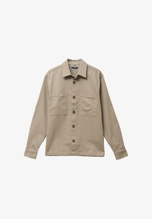 Beige langemouw shirt met een kraaghalslijn, twee voorzakken en donkere knopen, gemaakt van een lichte katoen stof.