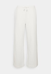 Witte katoenen joggingbroek met een elastische tailleband, aantrekkoord, zijzakken, wijd uitlopende pijpen en een gladde textuur.