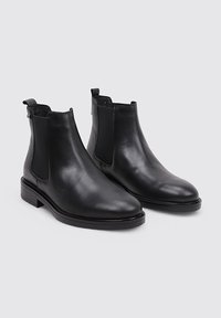 Black leather ankle boots with elastic side panels, rounded toe, and low block heel. Smooth texture with subtle stitching details.