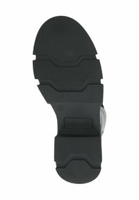Suola in gomma nera con un motivo di grip testurizzato. Presenta un'etichetta prominente con la scritta "CAPRICE" e la taglia "37". Bordo e contorni lisci.