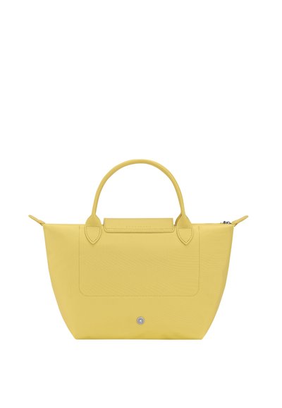 Yellow handbag with two handles, a flap closure on top, and a button snap detail on the front, displayed on a white background.