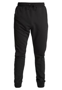 Svarta joggingsbyxor i mjukt material, med elastisk midja och dragsko, ribbade ärmslut och sidofickor.