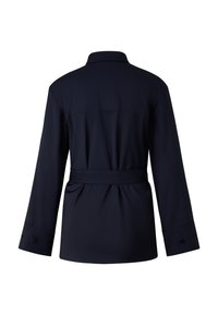 Navy blue belted jacket with long sleeves, button cuffs, and a back yoke detail. Made from soft, smooth fabric with a tailored fit.