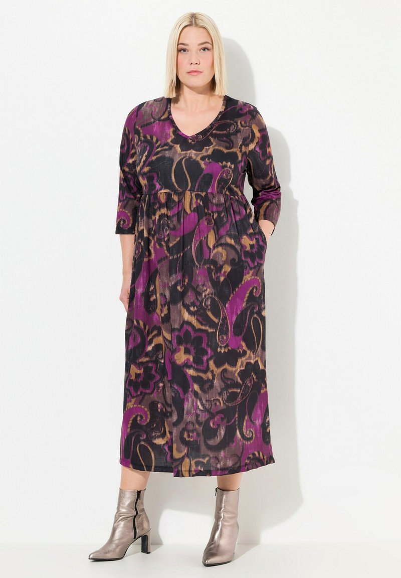 Robe longue à décolleté en V avec une silhouette fluide, ornée de motifs floraux noirs, violets et bruns. Présente des manches trois-quarts et des poches latérales.