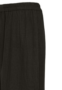 Pantalon noir à coupe ample avec taille élastique, fabriqué à partir d'un tissu léger et texturé.