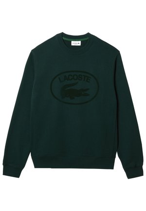 Ciemnozielona bluza z długim rękawem i okrągłym dekoltem z teksturowanym logo Lacoste oraz emblematem krokodyla na środku z przodu.