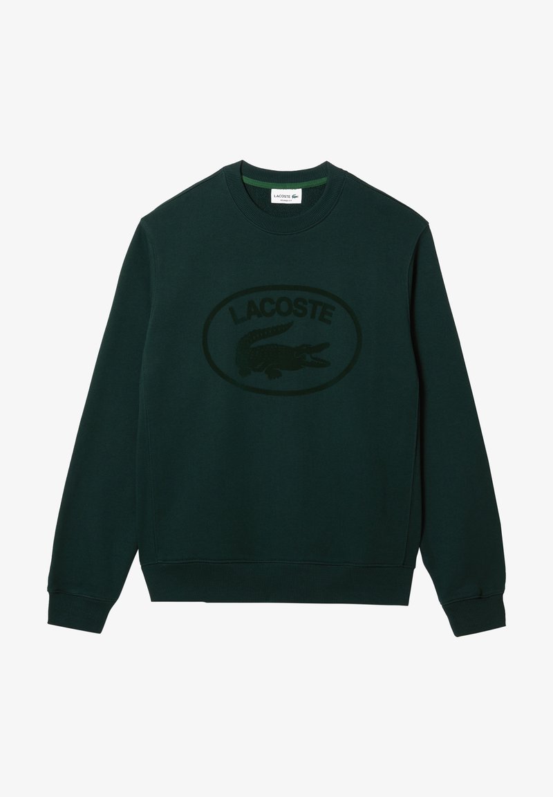 Sweat-shirt vert foncé à manches longues et col rond avec un logo Lacoste texturé et un emblème en forme de crocodile centré sur le devant.
