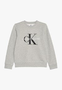 Szara bluza z miękkiej mieszanki bawełny, z czarnym logo "CK" i napisem "CALVIN KLEIN JEANS" z przodu. Klasyczny krój z okrągłym dekoltem.
