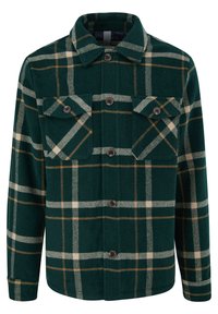 Camicia di flanella verde a quadri con due tasche sul petto, bottoni marroni e colletto strutturato. Il motivo include linee bianche e beige.