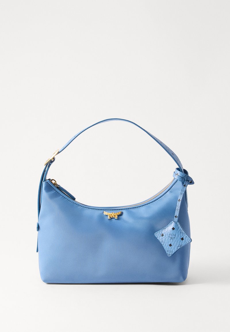 Blue faux leather handbag with a rounded shape, zipper closure, and a decorative tassel. Features a gold logo and textured diamond tag.