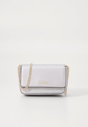 Silver crossbody bag made of textured material, featuring a gold chain strap and a front flap with embossed brand logo.