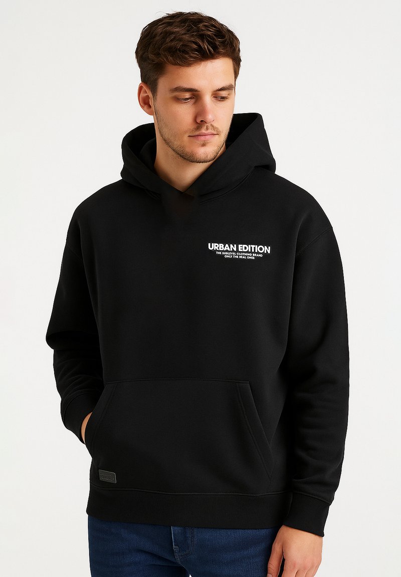 Black hoodie made of soft fabric, featuring a front pocket and a drawstring hood. "URBAN EDITION" logo printed in white on the chest.