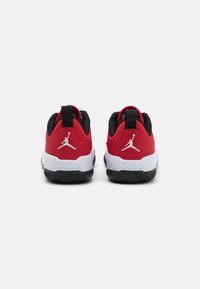 Czerwono-czarne buty sportowe o gładkiej fakturze, z białym logo Jumpman na pięcie oraz czarną gumową podeszwą z bieżnikiem.