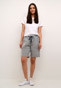 Striped cotton shorts with an elastic waistband and drawstring, featuring side pockets and a relaxed fit, paired with a white t-shirt.