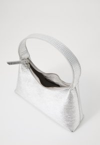 Sac à main argenté texturé avec une anse courbée, fermeture zippée et une doublure intérieure lisse. Design compact avec une forme rectangulaire.