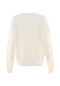 Maglione lavorato a maglia in bianco sporco con un motivo texturizzato, maniche ampie e dettagli in pizzo sulle spalle. Vestibilità casual con polsini a costine.