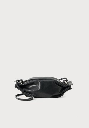Black leather crossbody bag with silver hardware and a zipper closure, lying flat on a white surface.