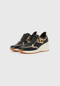 Black and beige wedge sneakers with leopard print accents, mesh panels, and a textured finish; featuring laces and a decorative zipper.