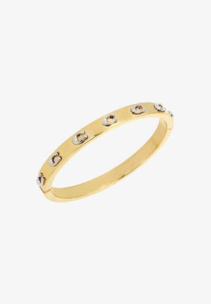 Gold bangle bracelet featuring circular silver accents. Smooth, polished metal with a rounded edge design, showcasing a sleek and minimalistic style.