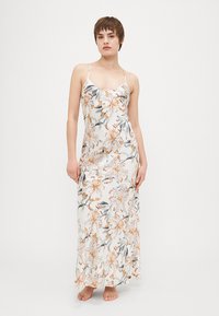 Floral maxi dress with thin adjustable straps, featuring a white background and orange and gray lily patterns. Smooth, lightweight fabric.