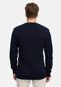 Granatowy sweter dzianinowy z prążkowanymi mankietami i dolnym brzegiem, z teksturowanym wzorem i dekoltem w kształcie łódki, pokazany z tyłu.