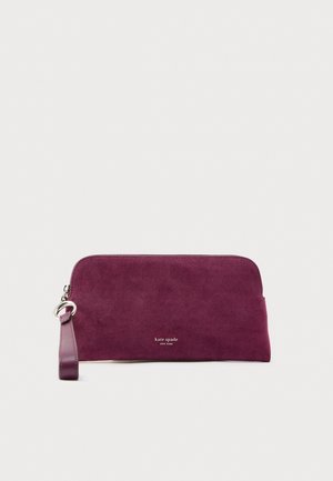 Purple suede clutch with a smooth finish, zipper closure, and a wrist strap. Features a silver-tone logo detail at the front.