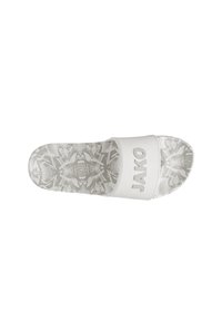 Witte slipper met een patroon op de zool. Beschikt over een brede band met "JAKO" in vetgedrukte letters. Textuur oppervlak voor grip en comfort.