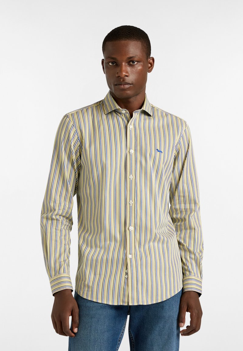 Raitapaita, jossa on keltainen, sininen ja valkoinen väri, slim fit -leikkaus, pitkät hihat ja pieni sininen logo rinnassa.