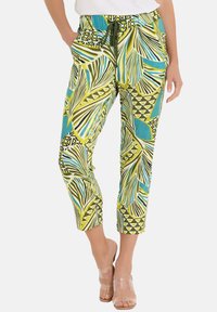 Gemusterte Hose aus leichtem Stoff mit grünen, blauen und schwarzen geometrischen und Blattmustern, mit elastischem Bund und Taschen.