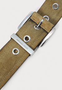 Tan suede belt with metal hardware, featuring holes and a silver-tone buckle with embossed "MICHAEL KORS" logo.
