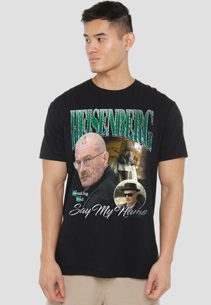 Black cotton t-shirt featuring a graphic design with "Heisenberg," images of characters, and text saying "Say My Name."