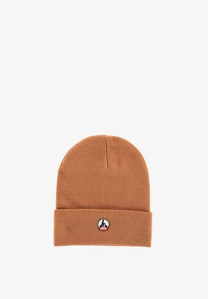 Brown knit beanie with a folded cuff and a small round patch featuring a black silhouette and red text "JOTT" on the front center.