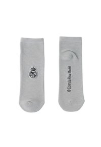 Chaussettes basses gris clair avec le logo du Real Madrid sur une et le texte "© Licencia Real Madrid" sur l'autre.