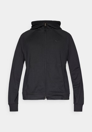 Melns rāvējslēdzēja džemperis ar kapuci, gludas auduma, ar raglana piedurknēm un priekšējām kabatām. Uz krūtīm ir neliels Nike logotips.