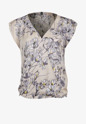 Blouse beige sans manches avec motif floral gris et jaune, col en V et ourlet légèrement froncé.