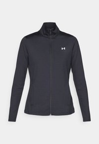 Svart zip-up jacka i stretchigt material med ståkrage och långa ärmar. Har en liten vit logotyp på vänster bröst.