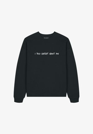 Sweatshirt noir avec du texte blanc qui dit : "J'AI PARLÉ À CHATGPT DE TOI." Design à col rond avec des poignets et un ourlet côtelés. Tissu doux au toucher.