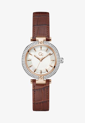 Bracelet de montre en cuir marron avec texture crocodile, boîtier argenté et lunette scintillante. Le cadran en nacre blanche présente des aiguilles et des index en or rose.