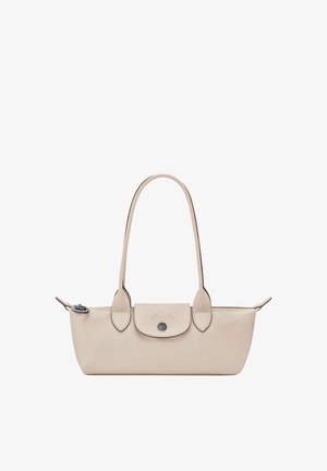 Small beige leather handbag with long handles, front flap pocket with button, and zipper closure on top.
