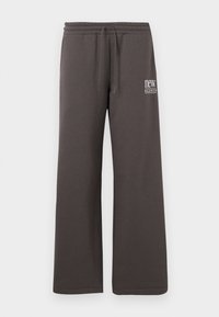 Σκούρο γκρι φαρδιά φόρμα με ελαστική μέση, κορδόνι και λευκό λογότυπο "new balance" στο αριστερό μηρό.