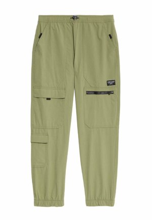 Pantalons cargo vert clair avec une taille élastique, plusieurs poches dont deux latérales et une poche zippée, et des poignets froncés aux chevilles.