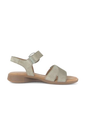 Light gray suede sandal with low brown sole, adjustable ankle strap, and wide front strap with cutout detail.